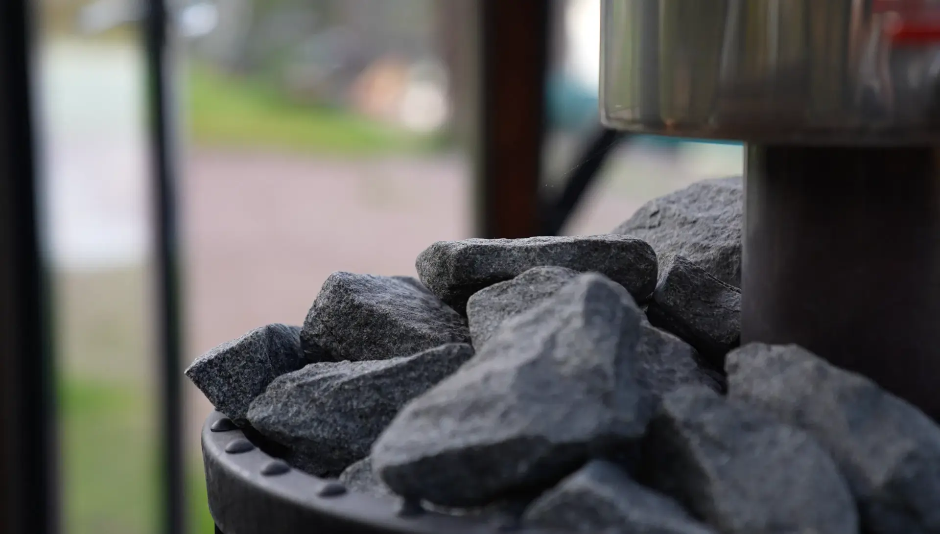 Close-up of hot sauna stones on the wood-burning stove inside the glass igloo