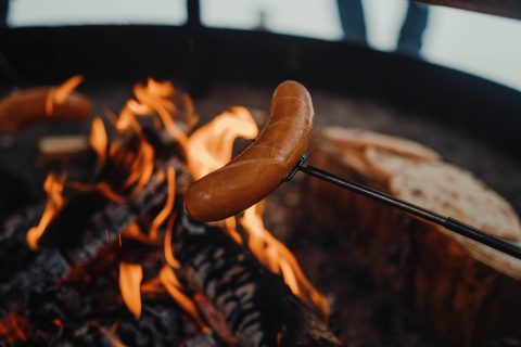 Sausage grilling over the campfire on the Korouoma tour