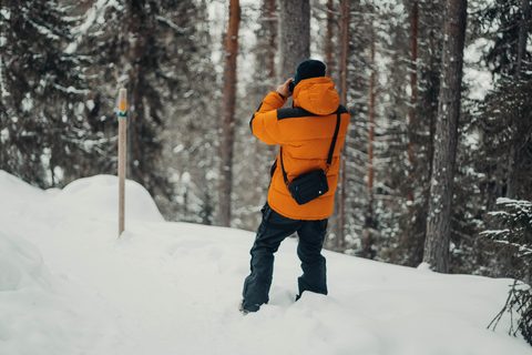 Hiker photographing the snowy forest on the Korouoma trail